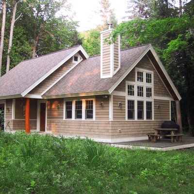 Cottage exterior on wooded lakefront lot  