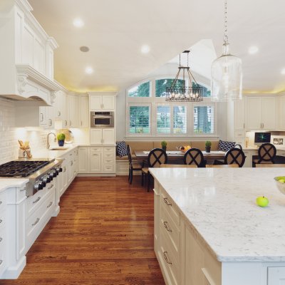 Sunlit white Kitchen with huge island, chandelier