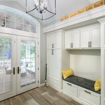 New Mud Room with built-in bench, white cabinets, french doors