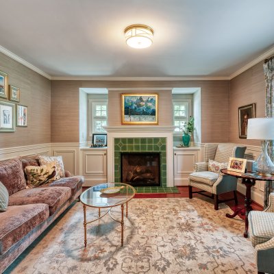 Former dining room reconfigured to living room with tile fireplace