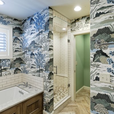 bathroom addition with decorative blue and white wallpaper  