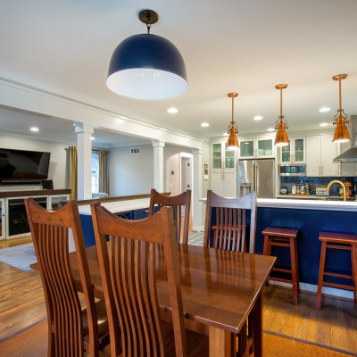 Kitchen and eating area blue and white with copper light fixtures