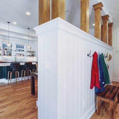 Coats hooks on half wall next to kitchen area Wilcox Architecture