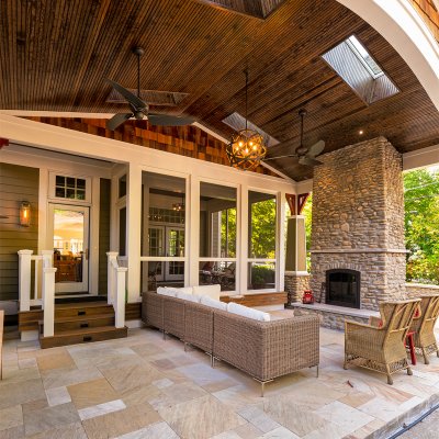 covered outdoor living space with sky lights and stone fireplace