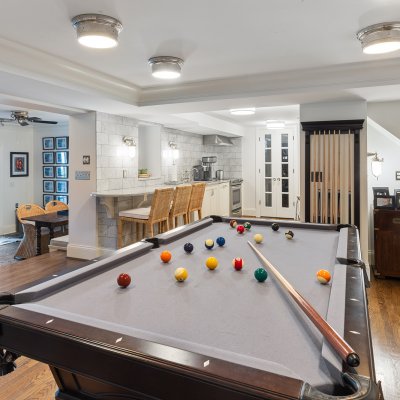 renovated basement billiards table new kitchenette modern lighting