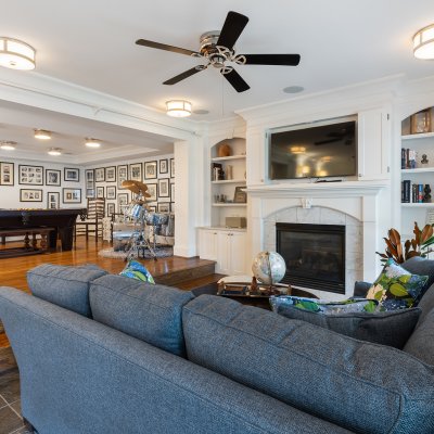 basement fireplace natural light ceiling fan TV over hearth