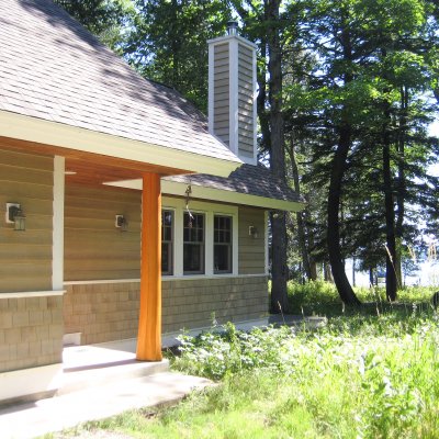 Natural cedar log column at entrance of new cottage Northern Michigan residential architecture