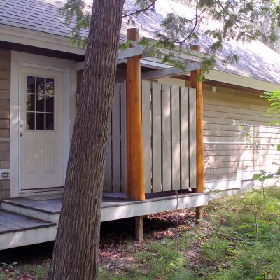 Outdoor shower with cedar log columns  