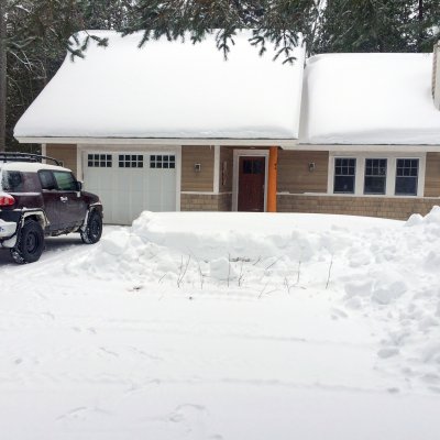 Snowy northern Michigan lake cottage driveway side